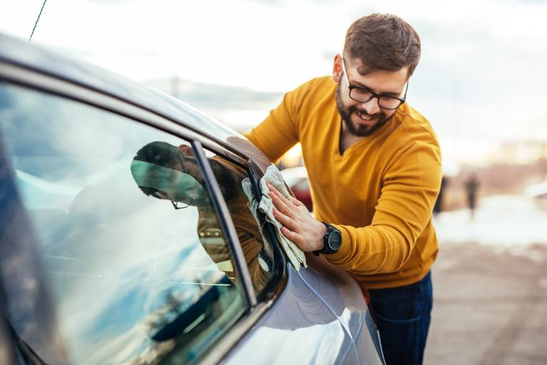 man preparing car for sale