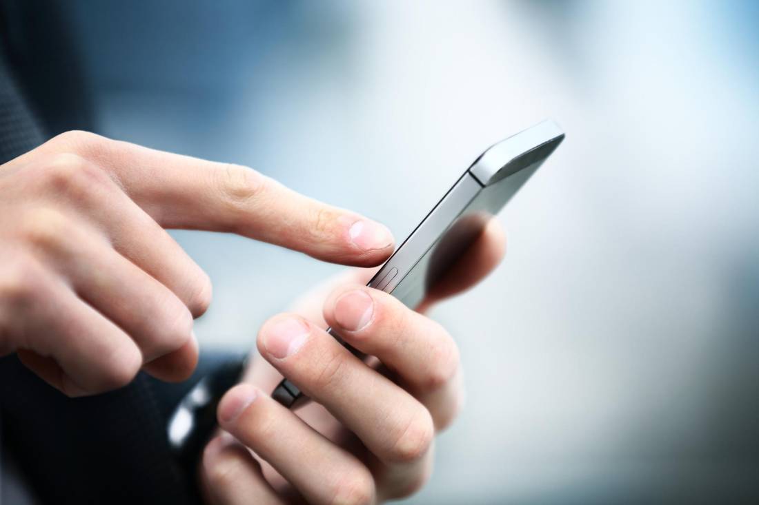 Close up of a man using mobile smart phone calling